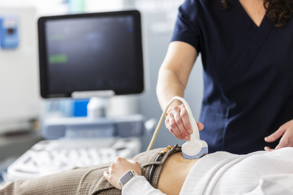 A fertility specialist performing a pelvic ultrasound on a patient.