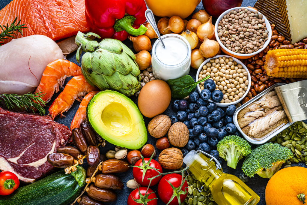 Mediterranean Diet foods, including fresh fruit and vegetables, lean meats, eggs, nuts, seeds and healthy fats like avocado. 